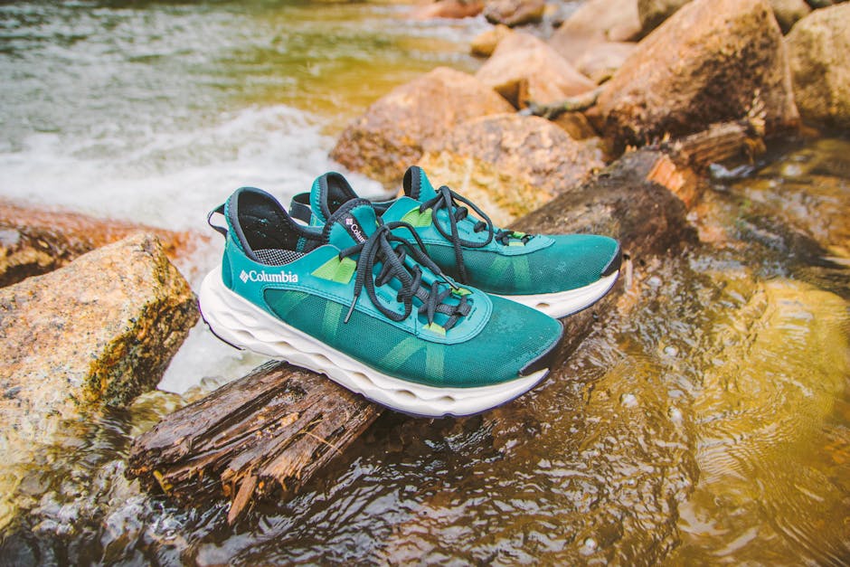 Teal hiking shoes on a log over a river in Đà Lạt, perfect for adventure and outdoor enthusiasts.